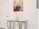 Hallway with modern glass table, chrome legs, art, and ample lighting at 1070 Splash Shot Pl, Davenport, FL 33896