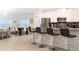 Modern kitchen with stainless steel appliances, sleek countertops, and bar stool seating at 1070 Splash Shot Pl, Davenport, FL 33896