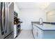 Modern kitchen featuring stainless steel appliances, white cabinetry, and gray countertops at 1070 Splash Shot Pl, Davenport, FL 33896