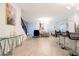 Open-concept living area featuring modern décor, tile floors, bar seating, and staircase at 1070 Splash Shot Pl, Davenport, FL 33896