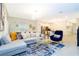 Open-concept living area with a large sectional, modern lighting, and views into the kitchen at 1070 Splash Shot Pl, Davenport, FL 33896