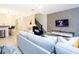 Open living space featuring stylish decor, a TV, and a glimpse of the staircase at 1070 Splash Shot Pl, Davenport, FL 33896