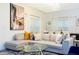 Spacious living room showcasing a comfortable sofa, stylish decor, and a view to the dining area at 1070 Splash Shot Pl, Davenport, FL 33896