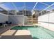 A private screened-in pool with comfortable seating, surrounded by an enclosed patio area at 1070 Splash Shot Pl, Davenport, FL 33896