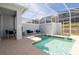Relaxing screened-in pool area featuring clear water, patio furniture, and a view of the surroundings at 1070 Splash Shot Pl, Davenport, FL 33896