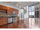 Open kitchen with stainless steel appliances, granite counters, and spiral staircase at 150 E Robinson St # 1023, Orlando, FL 32801