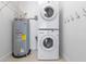 Convenient laundry closet featuring stacked washer and dryer along with water heater setup at 150 E Robinson St # 1023, Orlando, FL 32801