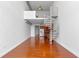 Open-concept living space with modern kitchen, spiral staircase and hardwood flooring at 150 E Robinson St # 1023, Orlando, FL 32801