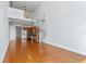 Open-concept living space with modern kitchen, spiral staircase and hardwood flooring at 150 E Robinson St # 1023, Orlando, FL 32801