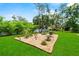 Landscaped backyard with drought resistant plants and a grill, perfect for outdoor cooking and entertaining at 1536 Pine Island Rd, Kissimmee, FL 34744