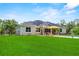Spacious backyard with pool, solar panels, and lush lawn, ideal for outdoor activities and entertaining guests at 1536 Pine Island Rd, Kissimmee, FL 34744