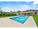 Sparkling in-ground pool surrounded by a spacious patio and lush green grass, perfect for summer fun and relaxation at 1536 Pine Island Rd, Kissimmee, FL 34744