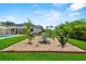 The home's beautiful backyard landscaping features a pool and outdoor seating in addition to drought resistant plants at 1536 Pine Island Rd, Kissimmee, FL 34744