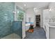 Bathroom with a modern shower, tub, double vanity, walk in closet, and blue tiled accents at 1536 Pine Island Rd, Kissimmee, FL 34744