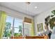 Bright dining room with modern light fixture, large window, and adjacent buffet at 1536 Pine Island Rd, Kissimmee, FL 34744