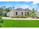 Charming single Gathering home features a paved driveway and attached garage, surrounded by lush landscaping at 1536 Pine Island Rd, Kissimmee, FL 34744