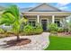 Inviting front entrance with a paved walkway and columns, framed by colorful plants and a healthy palm at 1536 Pine Island Rd, Kissimmee, FL 34744