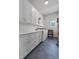 Clean laundry room featuring white cabinets, countertop, washer, and dryer at 1536 Pine Island Rd, Kissimmee, FL 34744