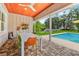 Outdoor patio featuring table, chairs, and views of the pool and backyard at 1536 Pine Island Rd, Kissimmee, FL 34744