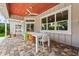 Covered outdoor patio with ample seating, a wood ceiling, and views of the pool at 1536 Pine Island Rd, Kissimmee, FL 34744