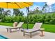Inviting backyard pool with lounge chairs and a table, perfect for relaxation and enjoying the outdoors at 1536 Pine Island Rd, Kissimmee, FL 34744