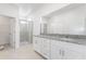 Bright bathroom featuring a double sink vanity with granite countertop and glass-enclosed shower at 1568 Gardiner St, Haines City, FL 33844