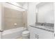 Well-lit bathroom with shower-tub combination and vanity with granite countertop at 1568 Gardiner St, Haines City, FL 33844