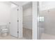 Clean bathroom with a walk-in shower, toilet, and an open view into a walk-in closet at 1568 Gardiner St, Haines City, FL 33844