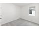 Empty bedroom featuring gray carpet, white walls, and a window with blinds at 1568 Gardiner St, Haines City, FL 33844