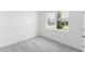 Neutral bedroom featuring a window with natural light, and plush carpet at 1568 Gardiner St, Haines City, FL 33844