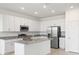Bright kitchen features white cabinets, granite countertops, stainless steel appliances, and a center island at 1568 Gardiner St, Haines City, FL 33844