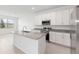 This kitchen is equipped with granite countertops, stainless steel appliances, white cabinets and an island at 1568 Gardiner St, Haines City, FL 33844