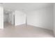 A large living room with neutral walls, tile flooring, and access to nearby rooms at 1568 Gardiner St, Haines City, FL 33844