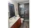 Modern bathroom featuring a double vanity and a glass-enclosed shower with dark tile at 160 Calabay Parc Blvd, Davenport, FL 33897