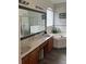 A well-lit bathroom with a bathtub, shower, and double vanity with a large mirror at 160 Calabay Parc Blvd, Davenport, FL 33897