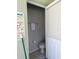 Small bathroom near the pool featuring a toilet and a towel rack with pool rules posted at 160 Calabay Parc Blvd, Davenport, FL 33897