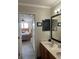 View of a bathroom featuring double sinks and the bedroom across the doorway at 160 Calabay Parc Blvd, Davenport, FL 33897