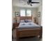 Cozy bedroom featuring a wooden bedframe, nightstands, lamps, and gray bedding at 160 Calabay Parc Blvd, Davenport, FL 33897