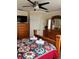 Well-furnished bedroom featuring wood furniture, ceiling fan, and a colorful quilted bedspread at 160 Calabay Parc Blvd, Davenport, FL 33897