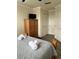 Cozy bedroom featuring a wooden wardrobe and a comfortable bed with fresh white towels at 160 Calabay Parc Blvd, Davenport, FL 33897