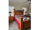 Inviting bedroom with wood furniture, matching nightstands, and a colorful quilt on the bed at 160 Calabay Parc Blvd, Davenport, FL 33897