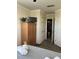 Bedroom features a wooden wardrobe, comfortable bed, and a full bathroom across the hallway at 160 Calabay Parc Blvd, Davenport, FL 33897