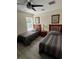 Bedroom featuring two beds with wood headboards, side table with lamp, and natural light at 160 Calabay Parc Blvd, Davenport, FL 33897