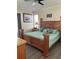 Spacious bedroom with decorative wood bedframe, patterned bedding, and wood-look flooring at 160 Calabay Parc Blvd, Davenport, FL 33897