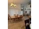 Bright dining room with hardwood floors, chandelier, and large table at 160 Calabay Parc Blvd, Davenport, FL 33897