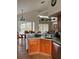 Charming kitchen with wood cabinets and stainless steel appliances, adjacent to a bright dining area at 160 Calabay Parc Blvd, Davenport, FL 33897