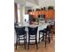 Kitchen featuring breakfast bar, wooden cabinets, and stainless-steel appliances at 160 Calabay Parc Blvd, Davenport, FL 33897
