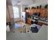 An open kitchen featuring warm wood cabinets, stainless appliances, and a sun-filled window at 160 Calabay Parc Blvd, Davenport, FL 33897