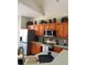 Bright kitchen featuring wooden cabinets and stainless steel appliances, with tile backsplash at 160 Calabay Parc Blvd, Davenport, FL 33897
