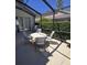 This screened patio features a table with four chairs and a grill, perfect for outdoor dining and entertaining at 160 Calabay Parc Blvd, Davenport, FL 33897